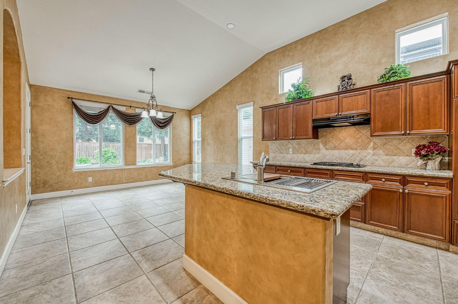 2267 Graybark Avenue Clovis, CA 93619 - Photo 17 of 42 a kitchen with stainless steel appliances granite countertop a sink window and cabinets