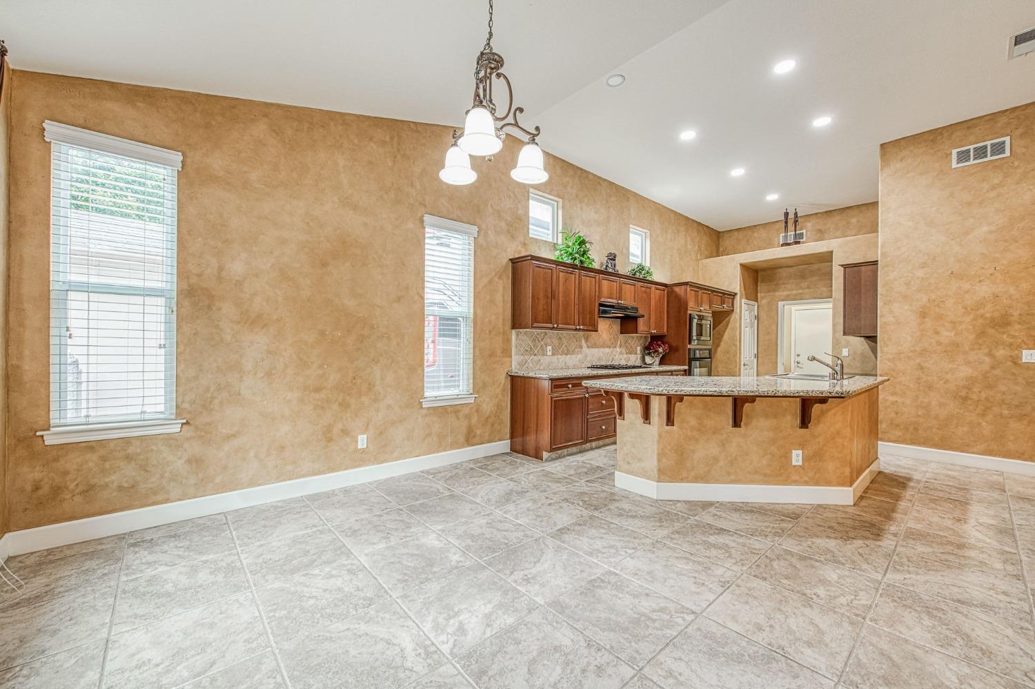 2267 Graybark Avenue Clovis, CA 93619 - Photo 21 of 42 a view of kitchen with cabinets microwave and stove