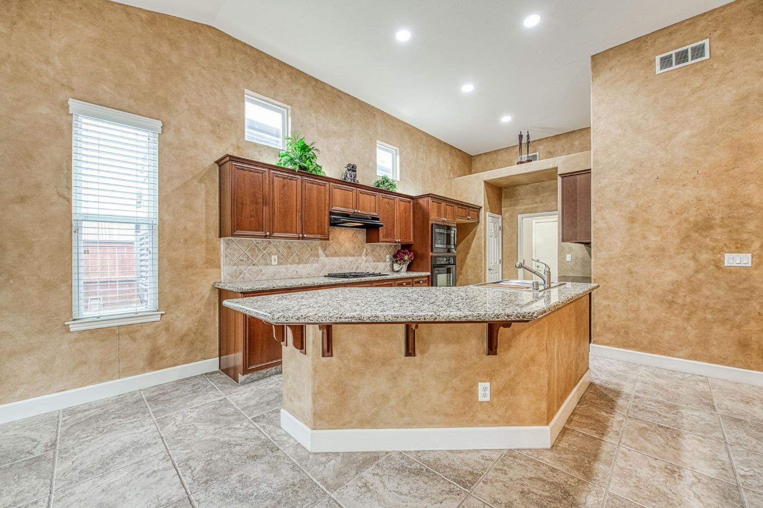2267 Graybark Avenue Clovis, CA 93619 - Photo 23 of 42 a view of kitchen with stainless steel appliances granite countertop a stove top oven