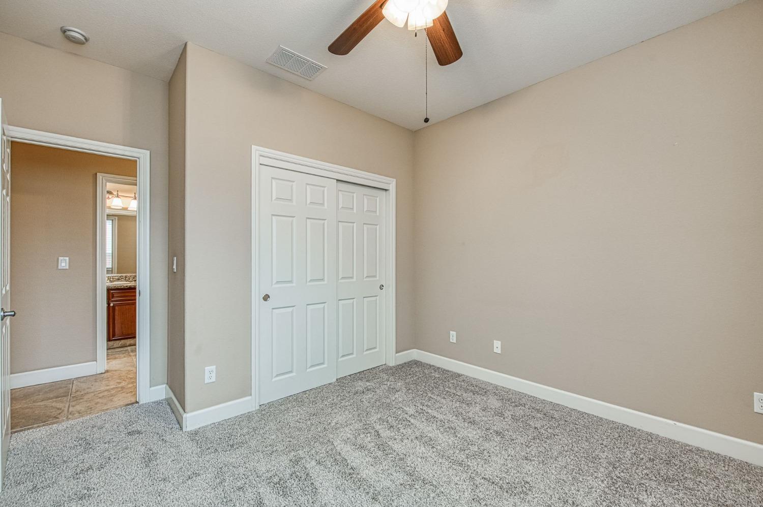 2267 Graybark Avenue Clovis, CA 93619 - Photo 28 of 42 an empty room with a empty space and a ceiling fan