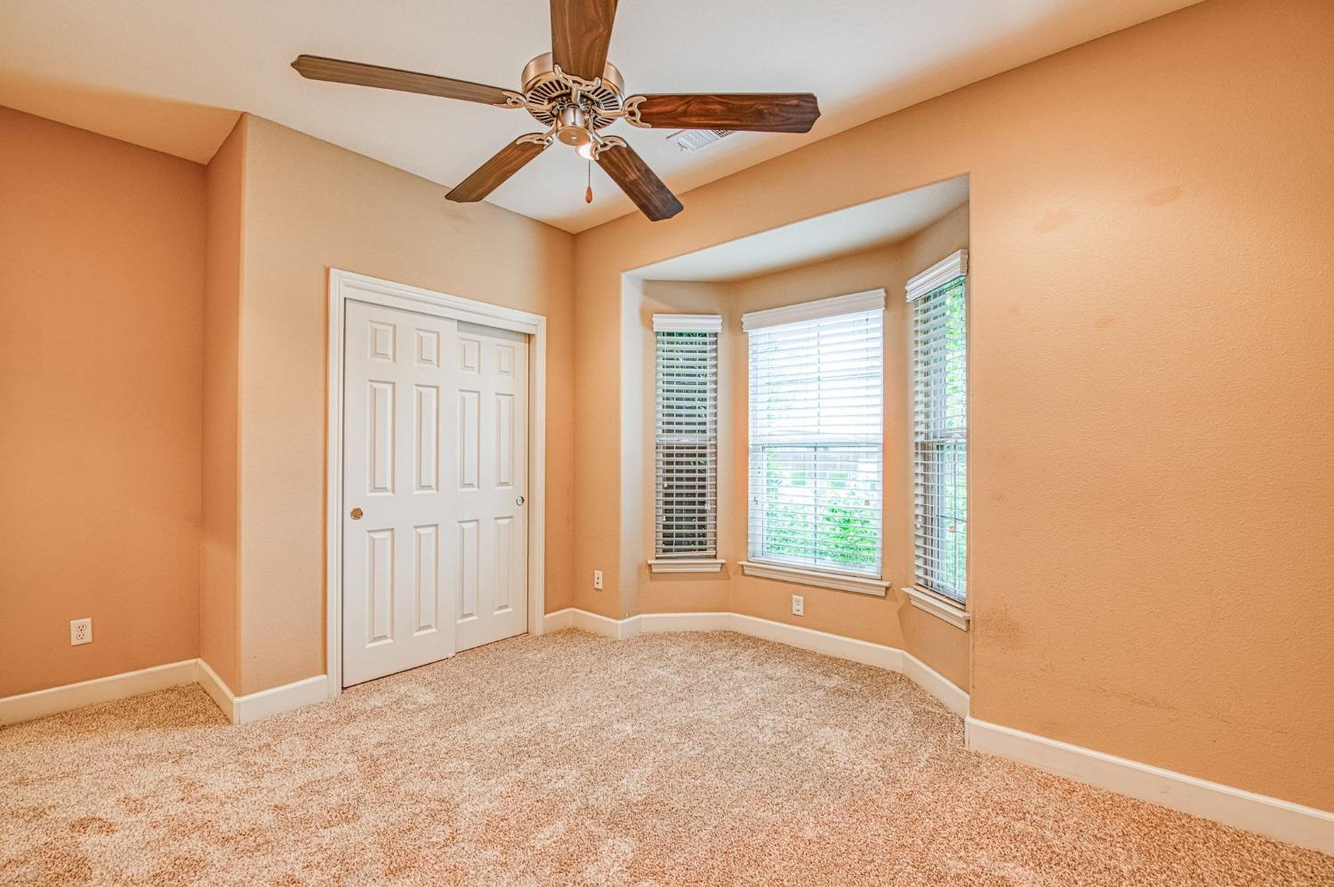 2267 Graybark Avenue Clovis, CA 93619 - Photo 31 of 42 a view of a livingroom with a chandelier fan and windows