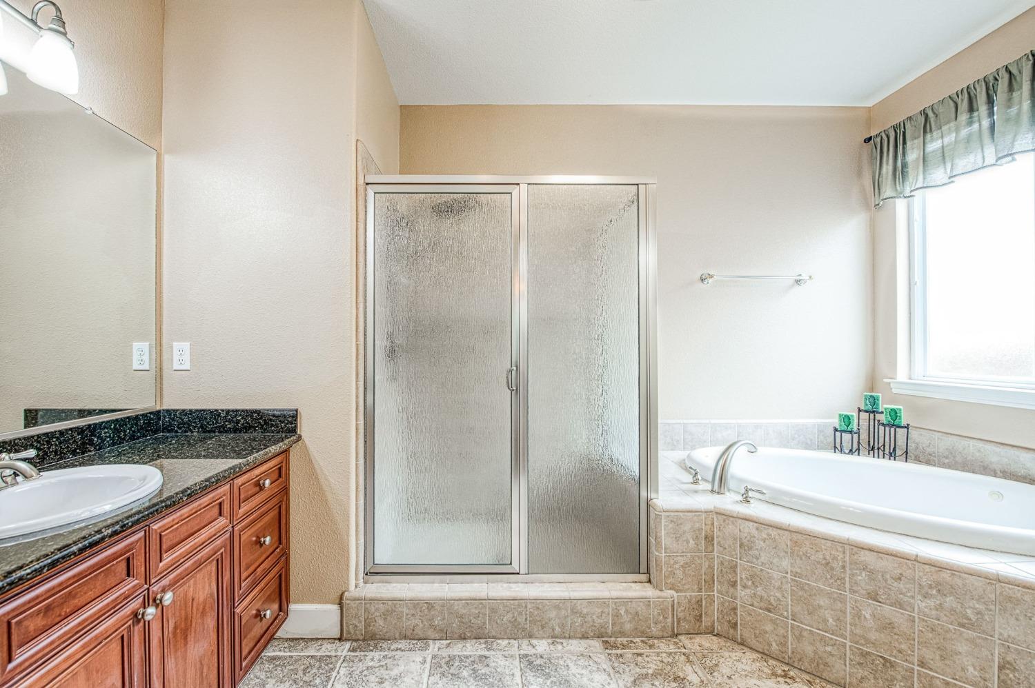 2267 Graybark Avenue Clovis, CA 93619 - Photo 32 of 42 a bathroom with a granite countertop sink and a mirror