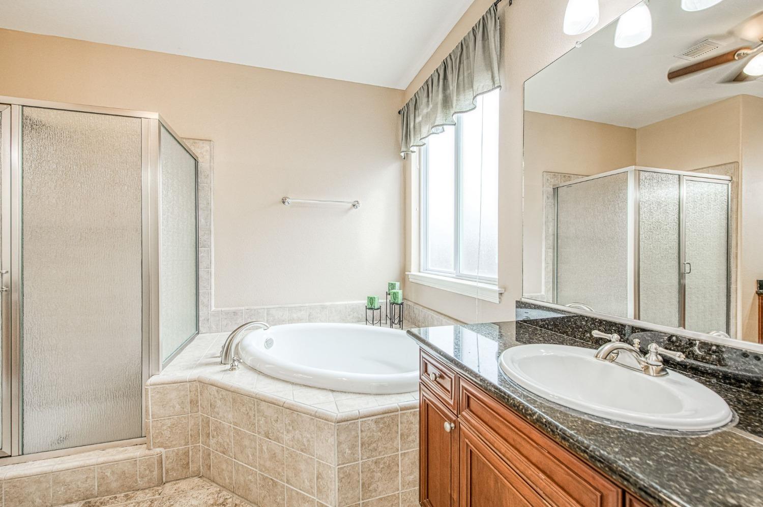 2267 Graybark Avenue Clovis, CA 93619 - Photo 33 of 42 a bathroom with a granite countertop sink and a mirror