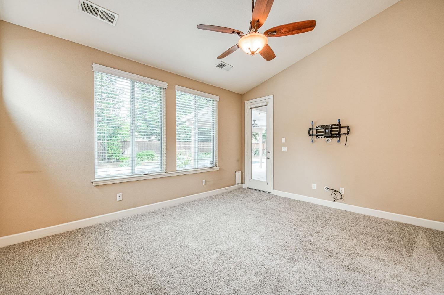 2267 Graybark Avenue Clovis, CA 93619 - Photo 34 of 42 an empty room with windows and fan