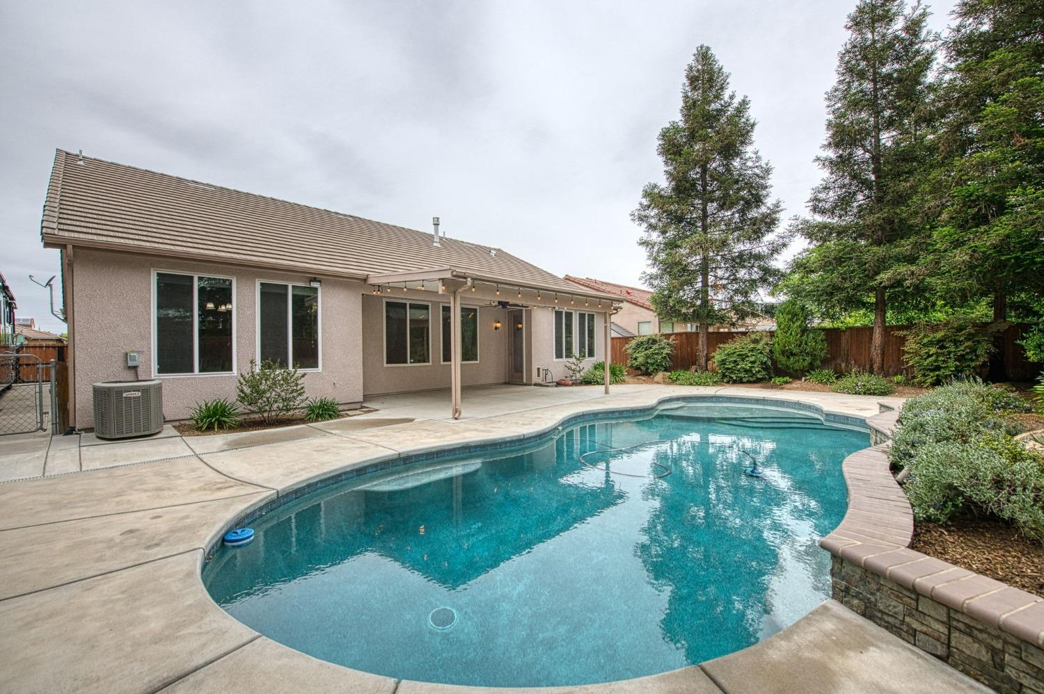 2267 Graybark Avenue Clovis, CA 93619 - Photo 40 of 42 a view of a house with swimming pool