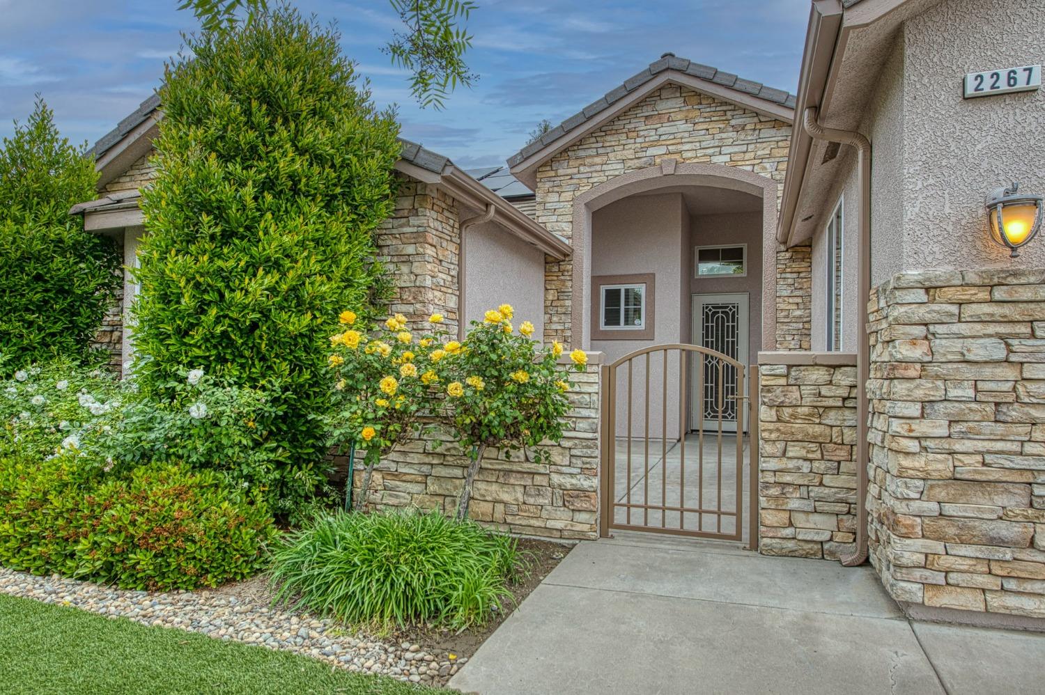 2267 Graybark Avenue Clovis, CA 93619 - Photo 4 of 42 front view of a house with a door