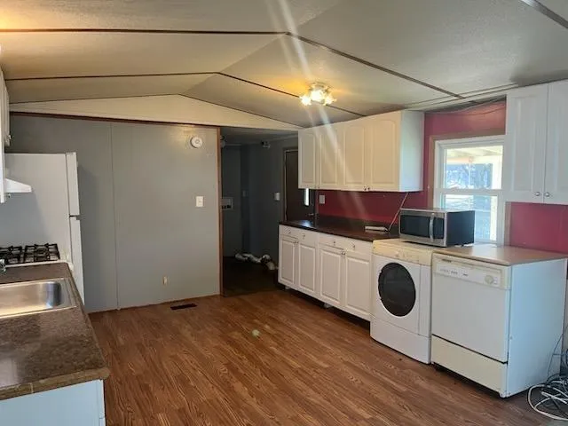 a kitchen with a stove a microwave and a refrigerator