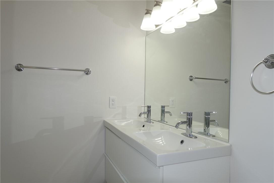 1311 Southwest 12th Avenue Boca Raton, FL 33486 - Photo 16 of 66 a bathroom with a sink a mirror and a light fixture