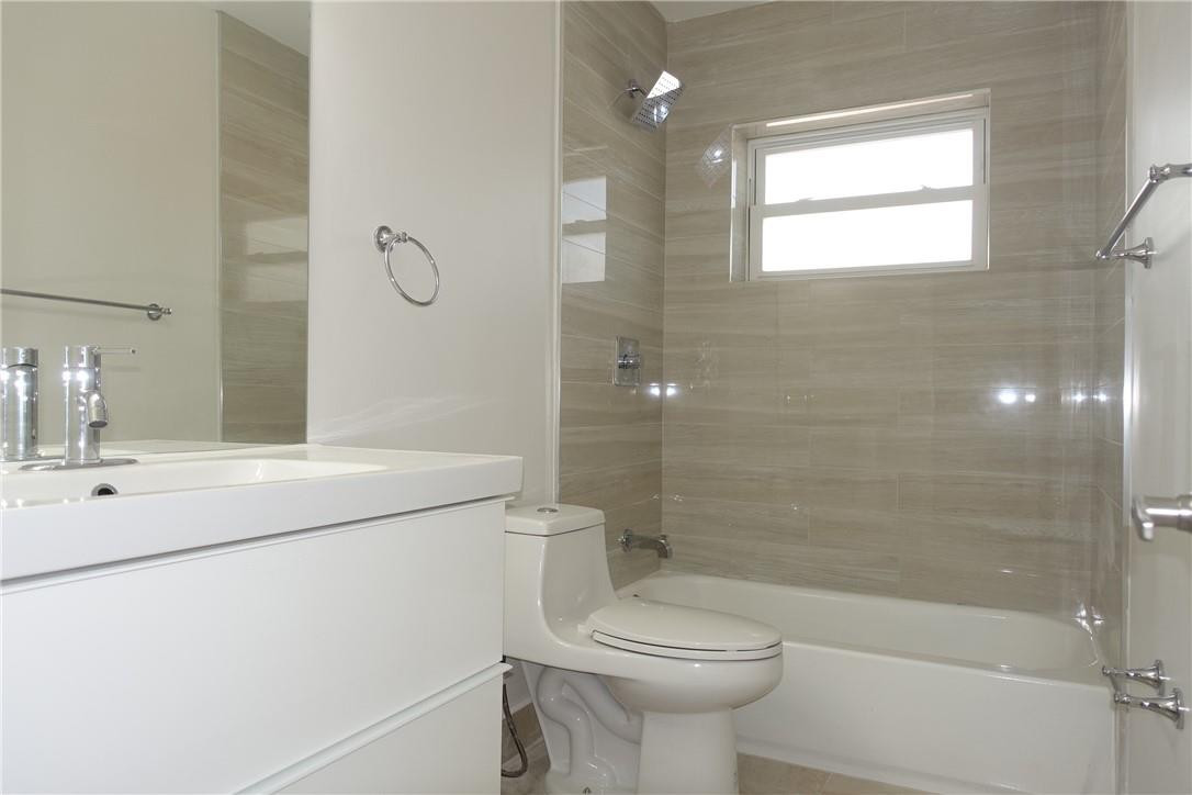 1311 Southwest 12th Avenue Boca Raton, FL 33486 - Photo 21 of 66 a bathroom with a sink a toilet and shower