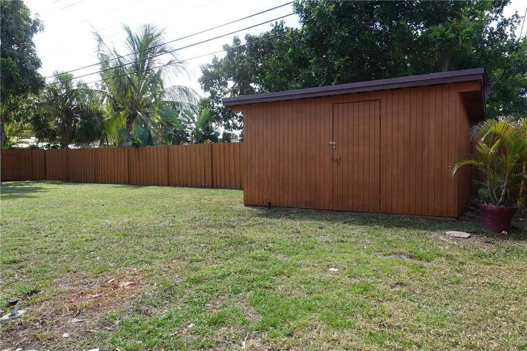 1311 Southwest 12th Avenue Boca Raton, FL 33486 - Photo 33 of 66 a view of backyard with potted plants and wooden fence
