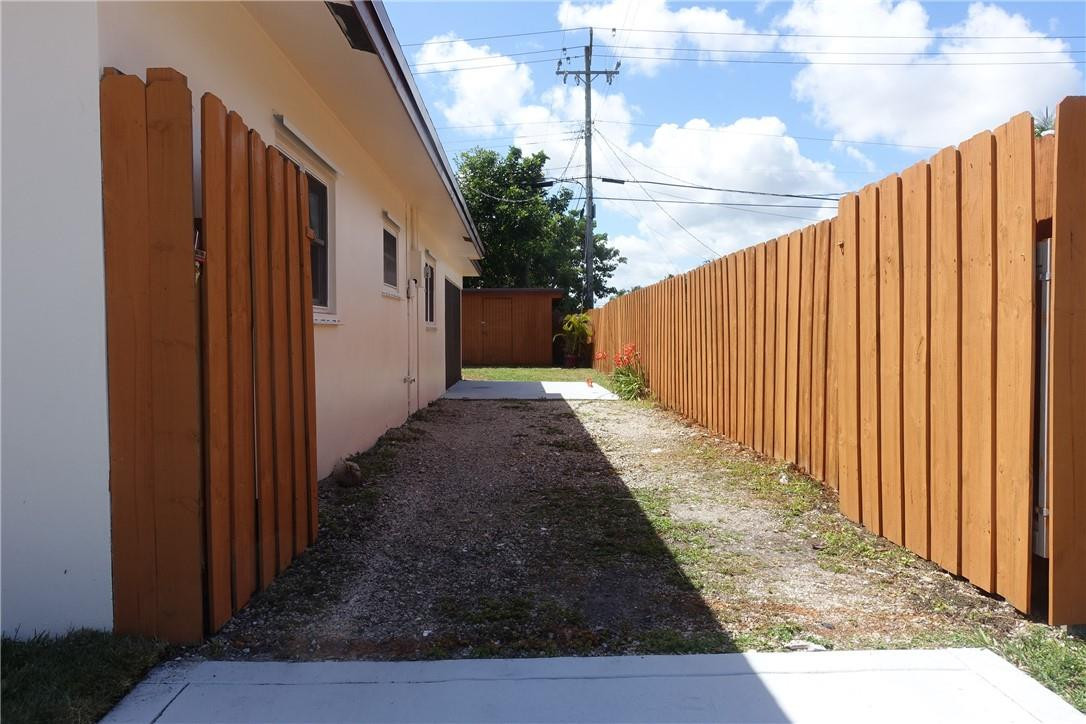 1311 Southwest 12th Avenue Boca Raton, FL 33486 - Photo 36 of 66 a view of a pathway of a wooden fence