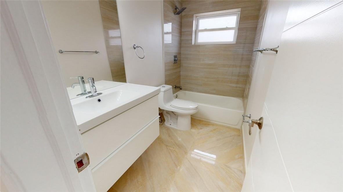 1311 Southwest 12th Avenue Boca Raton, FL 33486 - Photo 48 of 66 a bathroom with a sink a toilet and shower
