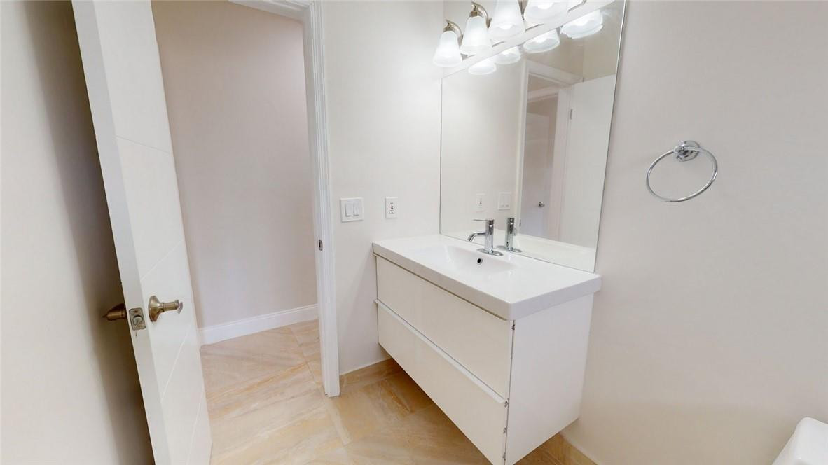 1311 Southwest 12th Avenue Boca Raton, FL 33486 - Photo 49 of 66 a bathroom with a sink vanity and a mirror
