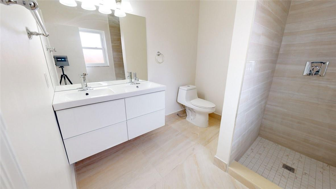 1311 Southwest 12th Avenue Boca Raton, FL 33486 - Photo 56 of 66 a bathroom with a sink a toilet and shower