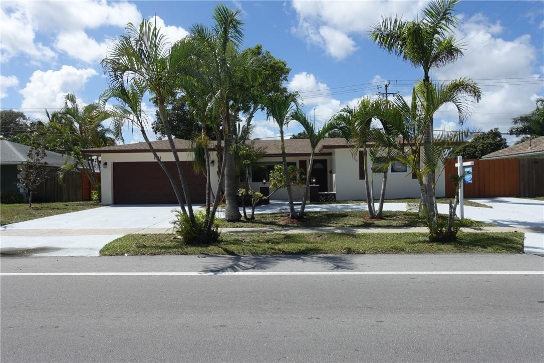 1311 Southwest 12th Avenue Boca Raton, FL 33486 - Photo 64 of 66 a front view of house with yard and green space