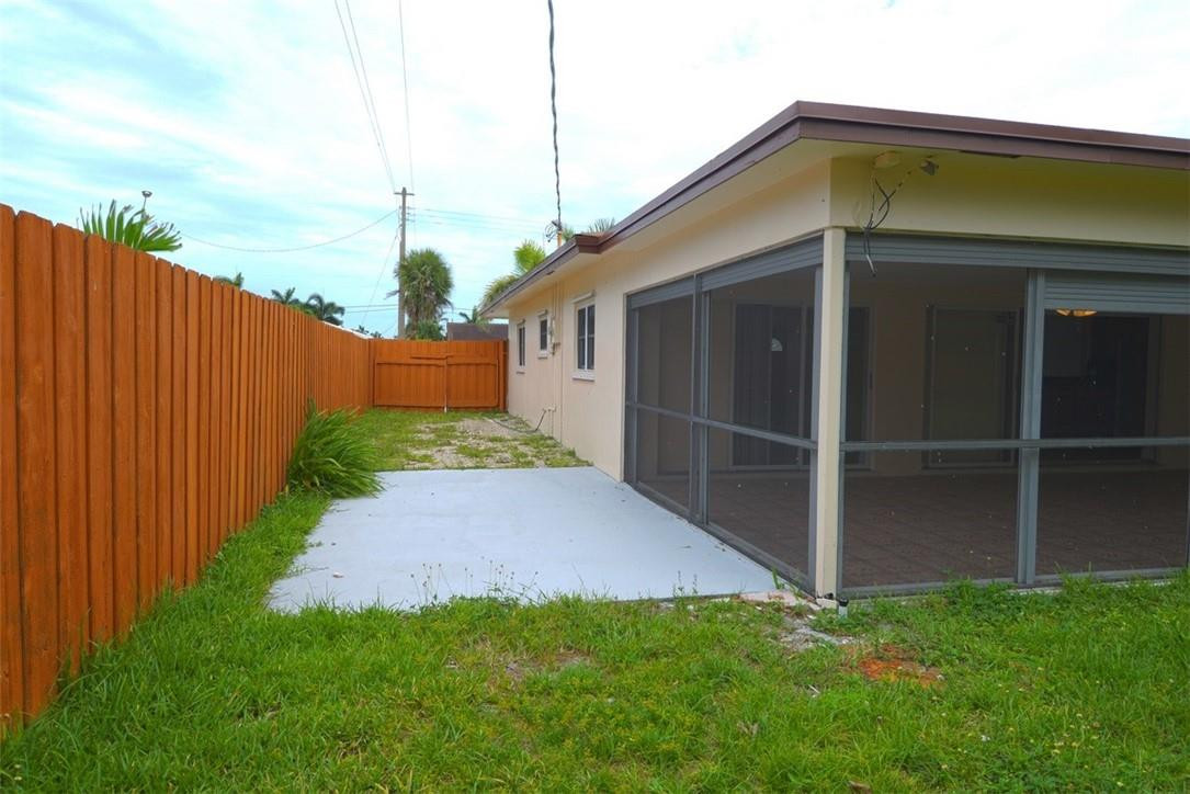 1311 Southwest 12th Avenue Boca Raton, FL 33486 - Photo 65 of 66 a front view of a house having yard