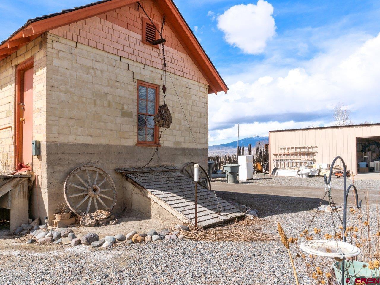 477 1600 Road Delta, CO 81416 - Photo 11 of 23 a building exterior with furniture and a table