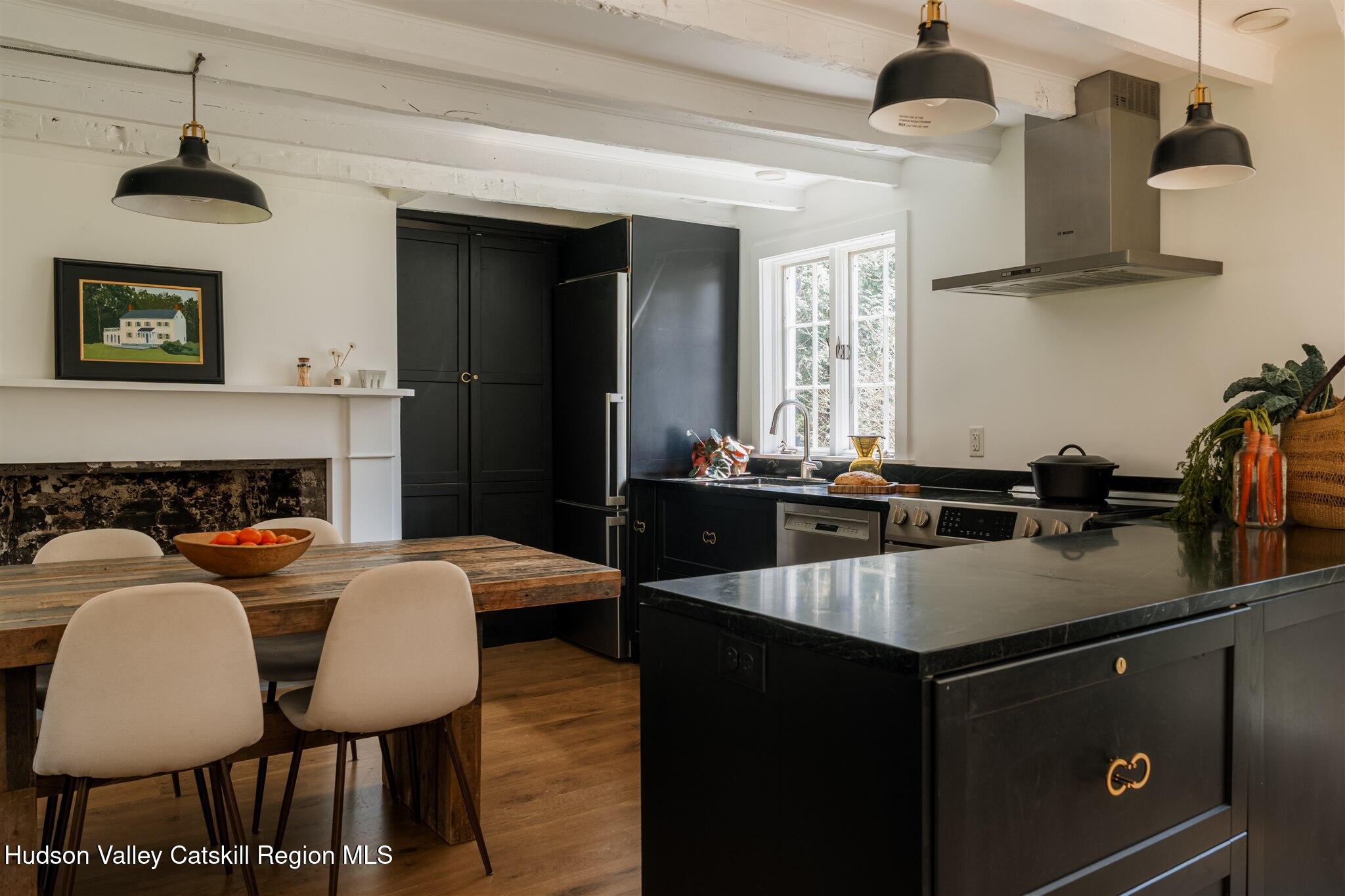 15 Dashville Road New Paltz, NY 12561 - Photo 15 of 38 a kitchen with a table chairs stove and microwave