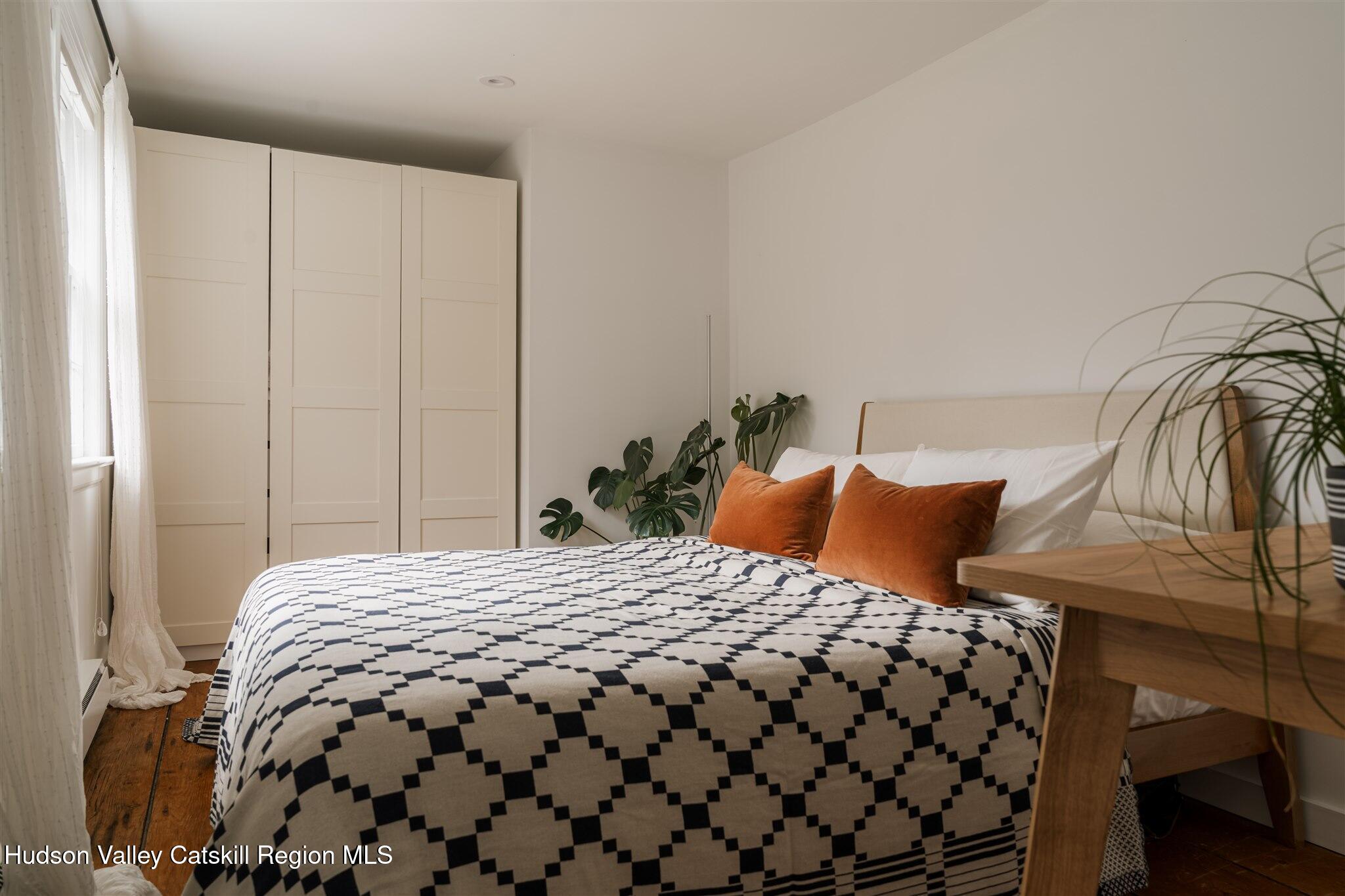 15 Dashville Road New Paltz, NY 12561 - Photo 32 of 38 a bedroom with a bed and two mirror