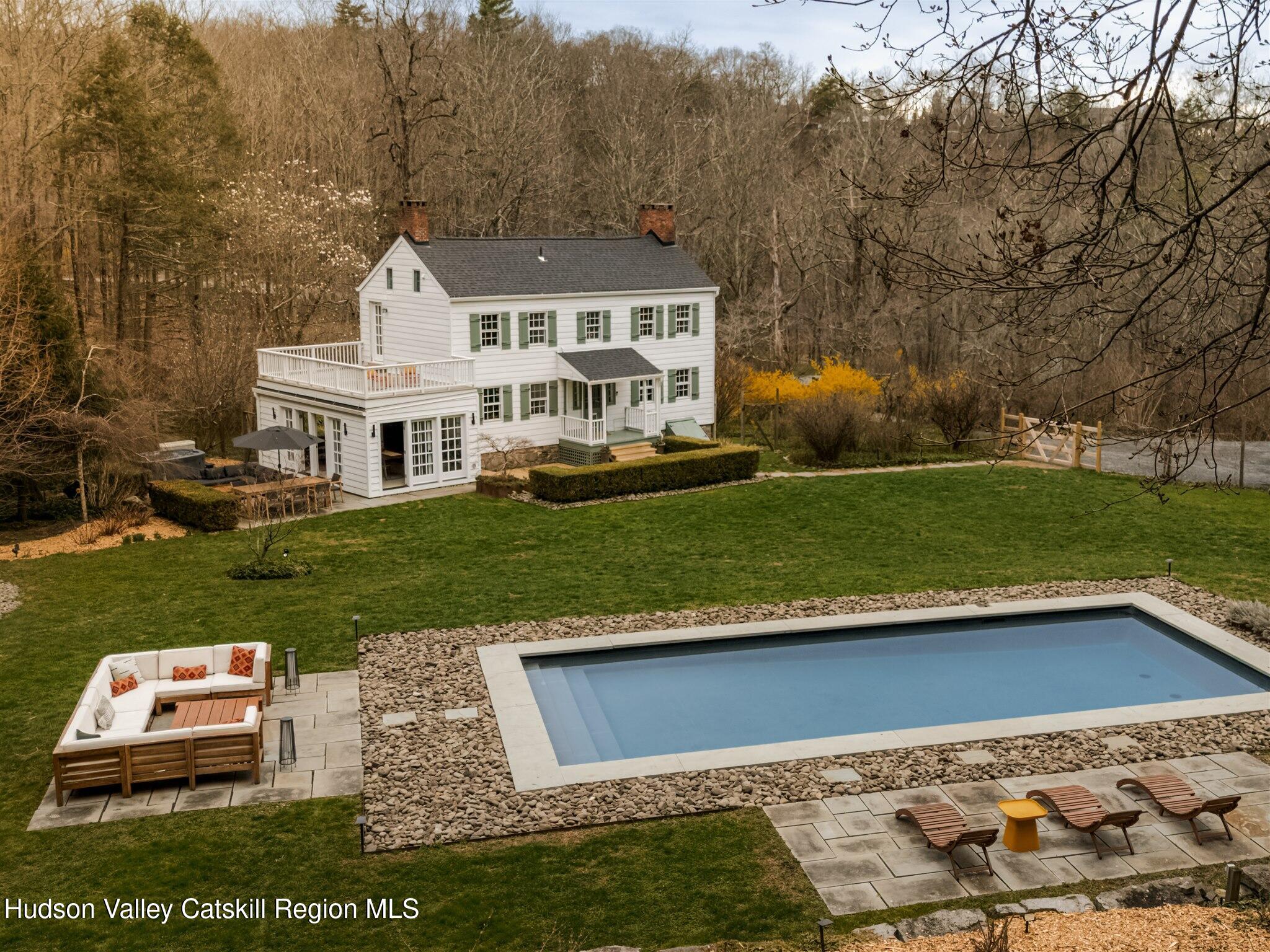 15 Dashville Road New Paltz, NY 12561 - Photo 5 of 38 a view of a white house next to a yard with big trees