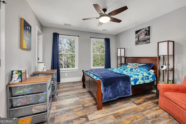 a view of a dining room with furniture a chandelier and wooden floor
