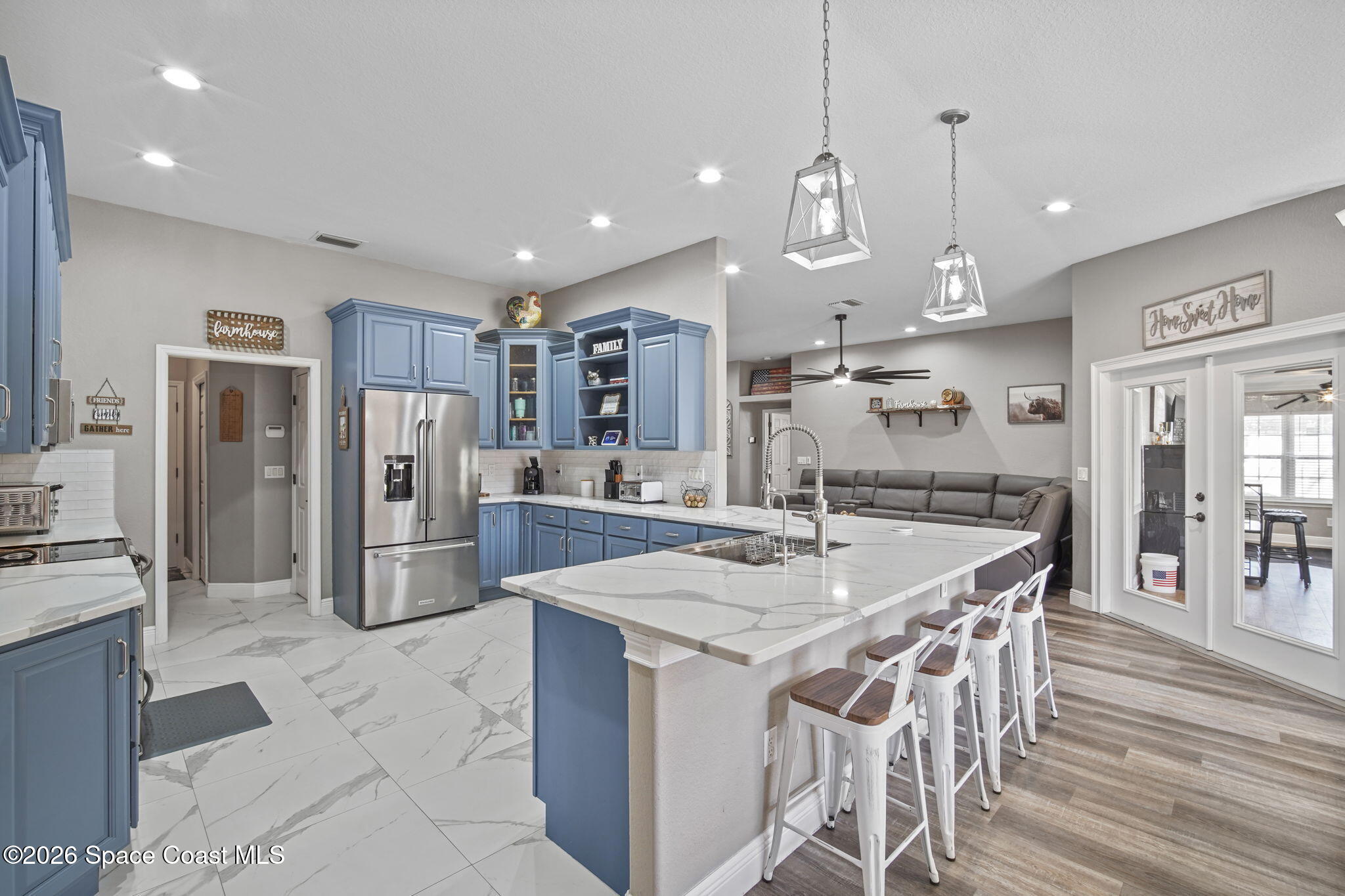 1845 Turpentine Road Mims, FL 32754 - Photo 11 of 33 a kitchen with stainless steel appliances kitchen island granite countertop a refrigerator a sink a stove a dining table and chairs