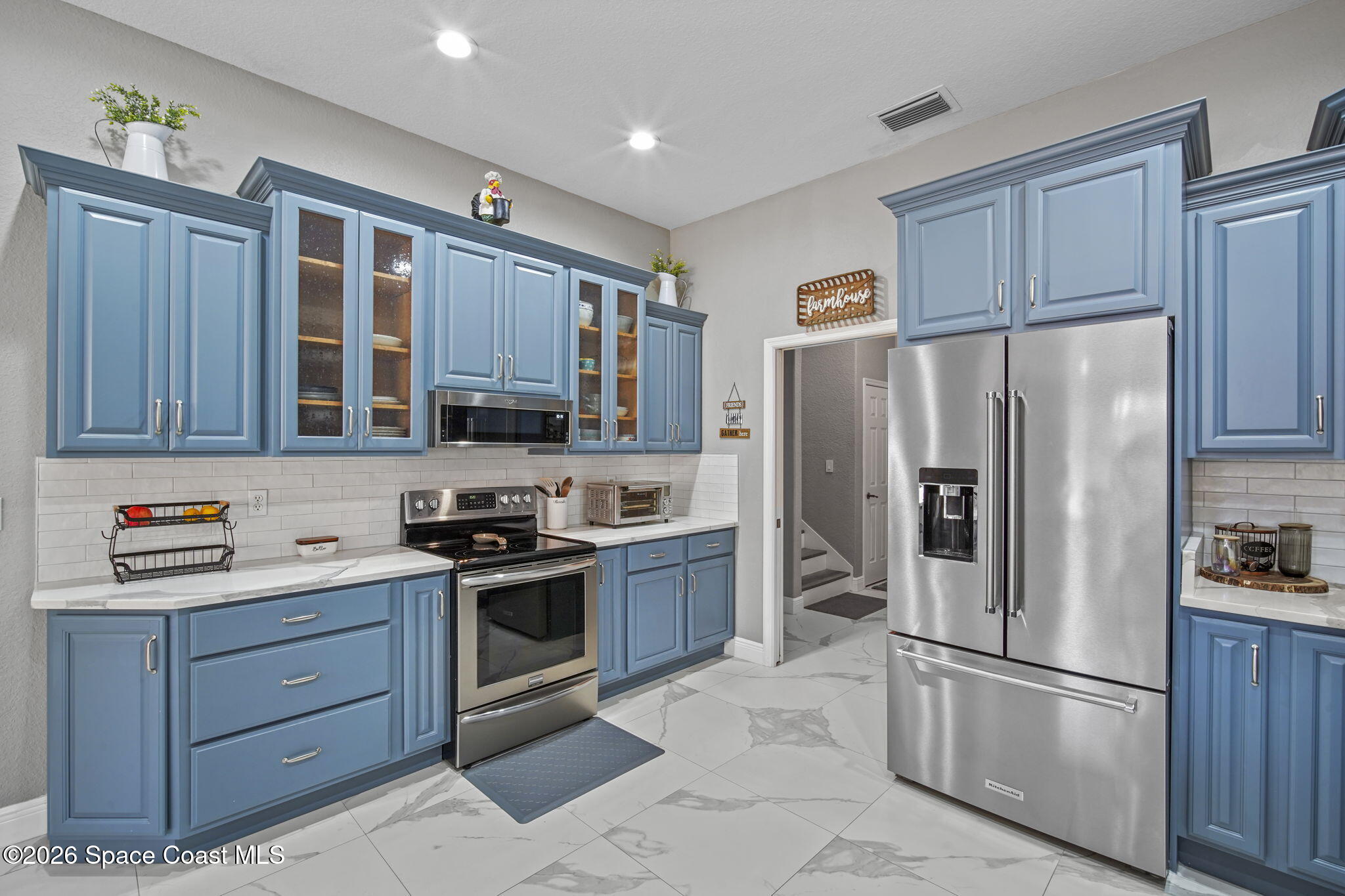 1845 Turpentine Road Mims, FL 32754 - Photo 12 of 33 a kitchen with stainless steel appliances granite countertop a refrigerator stove and sink