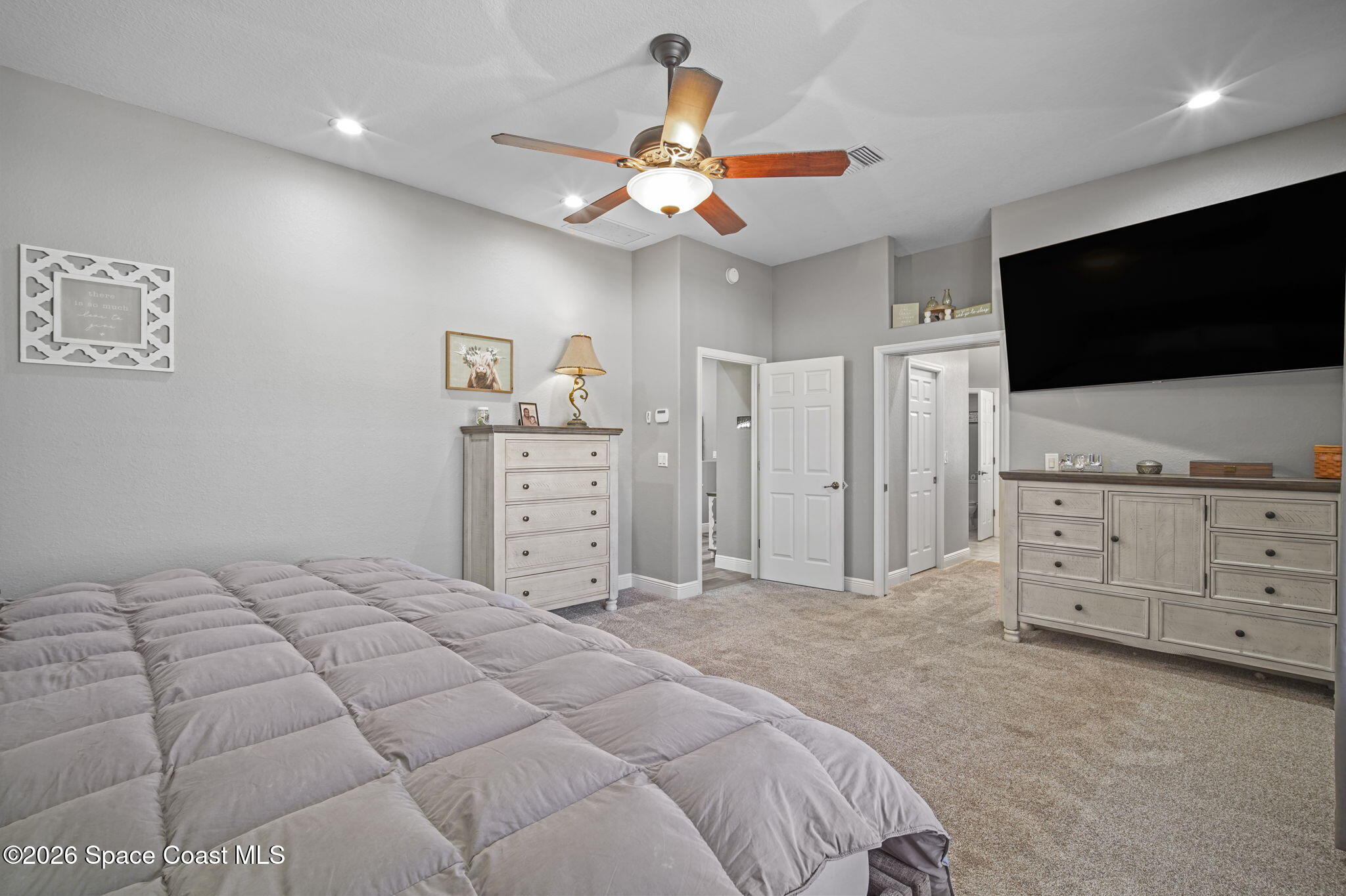 1845 Turpentine Road Mims, FL 32754 - Photo 17 of 33 a bedroom with a large bed and a flat screen tv