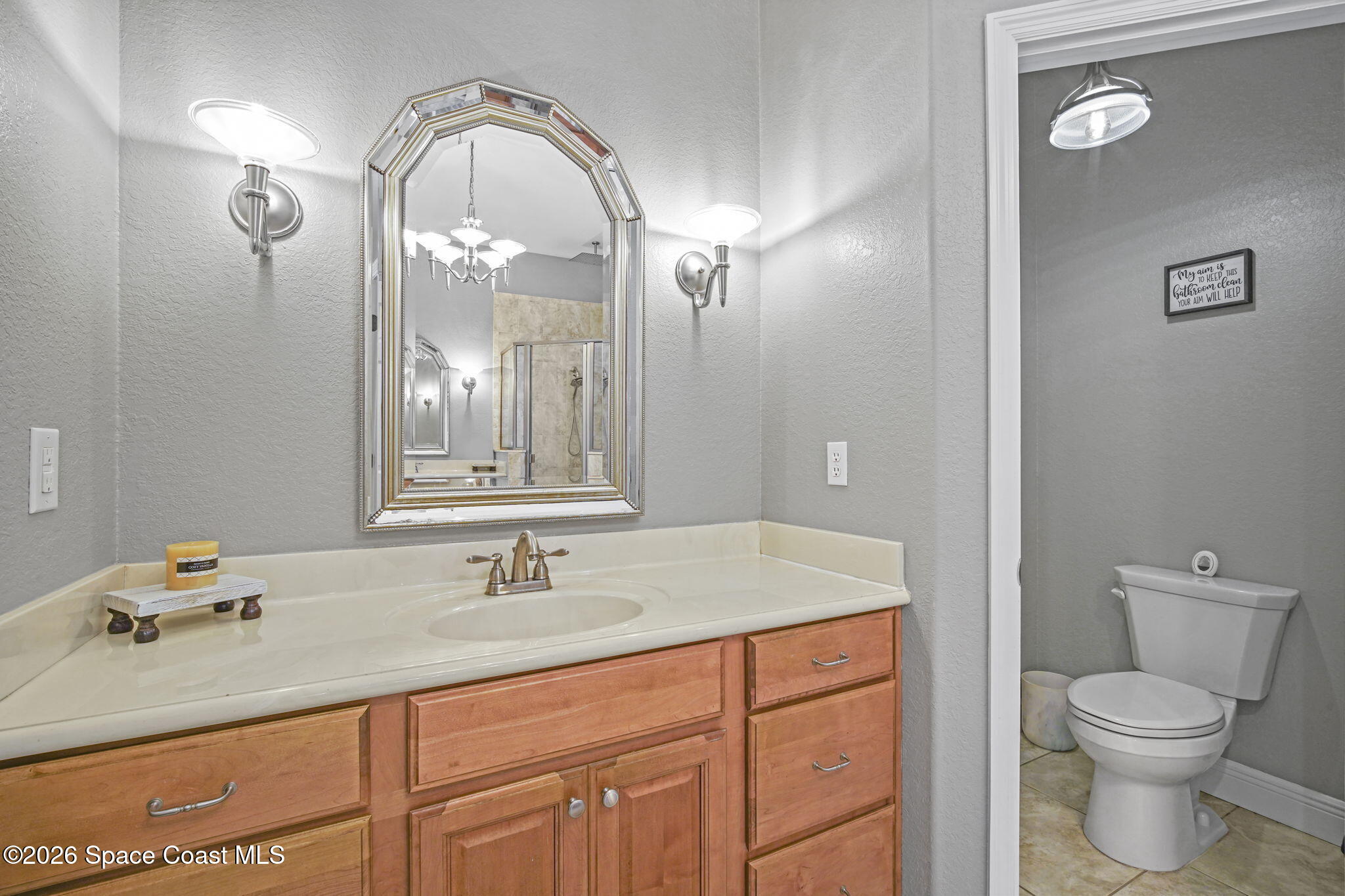 1845 Turpentine Road Mims, FL 32754 - Photo 19 of 33 a bathroom with a granite countertop sink a toilet and a mirror