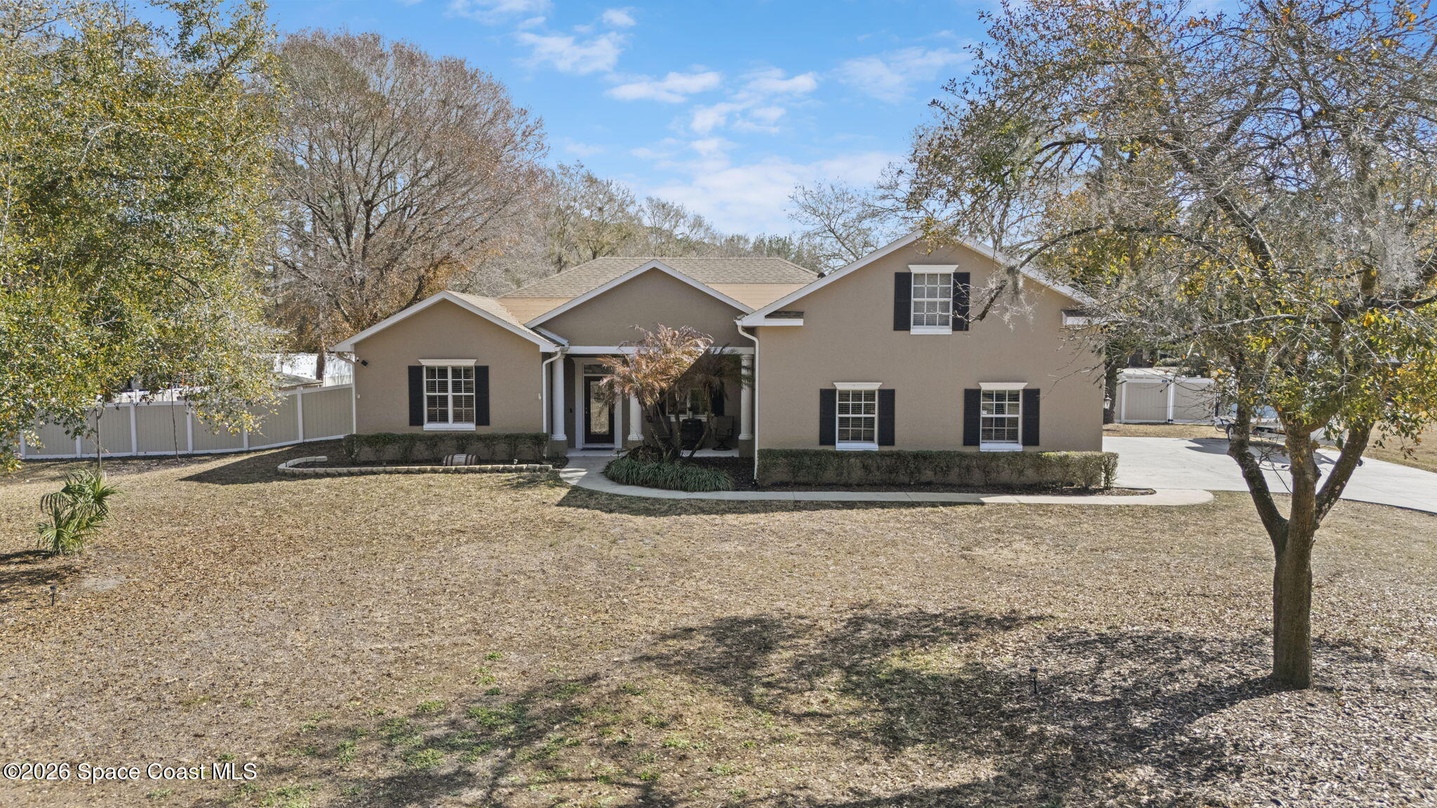 1845 Turpentine Road Mims, FL 32754 - Photo 2 of 33 a view of a yard in front of a house with large trees