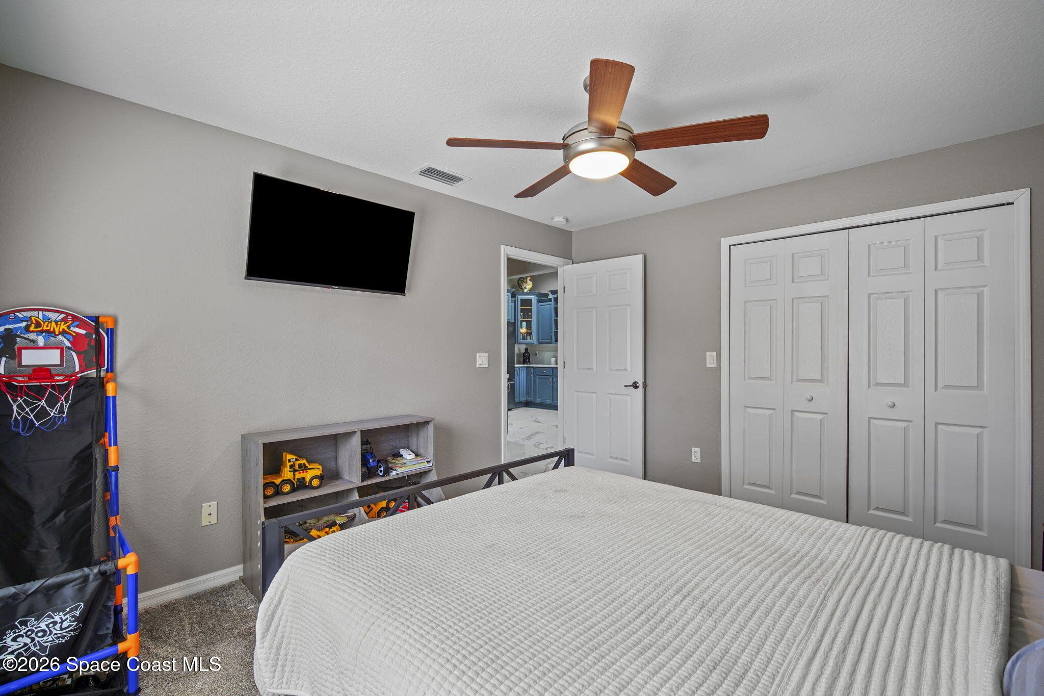 1845 Turpentine Road Mims, FL 32754 - Photo 24 of 33 a bedroom with a bed and a flat screen tv