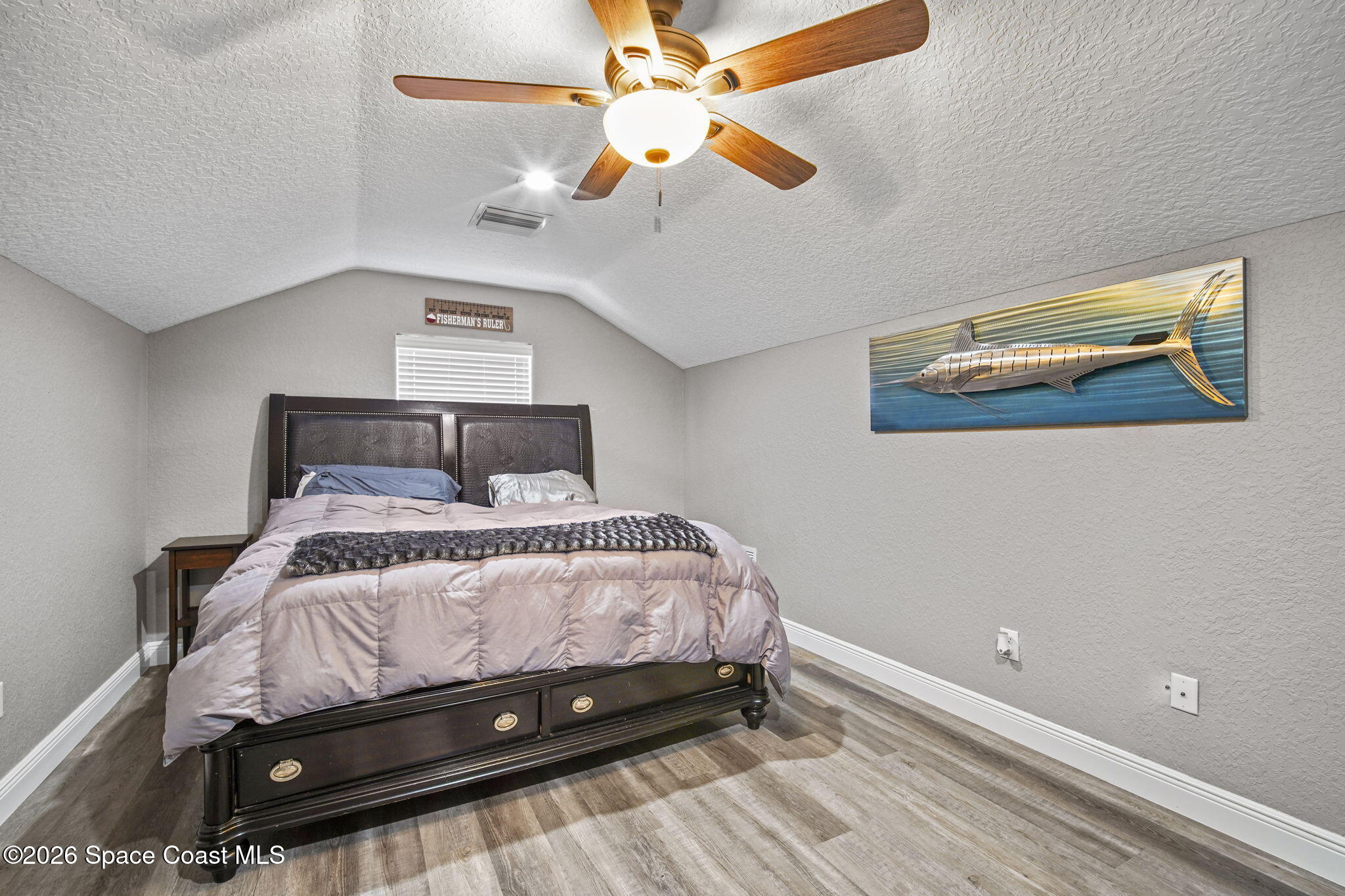 1845 Turpentine Road Mims, FL 32754 - Photo 30 of 33 a bedroom with a bed and a chandelier