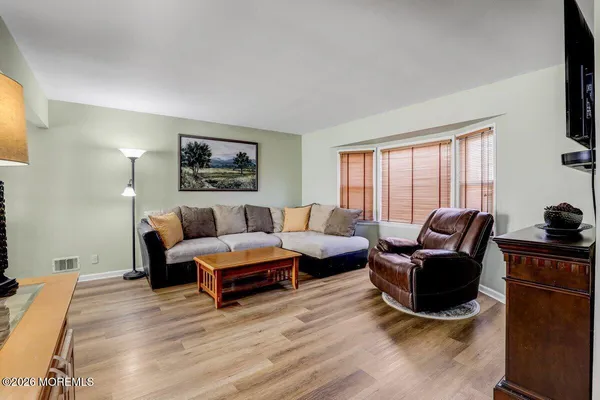 a living room with furniture rug and window