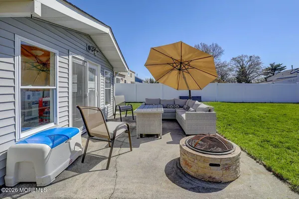 a view of a patio with table and chairs under an umbrella