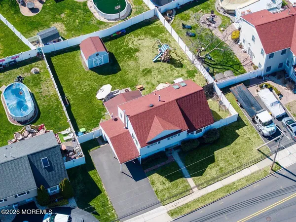 an aerial view of a house with garden space and street view