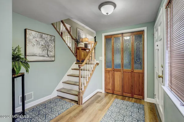 a view of entryway with stairs and wooden floor
