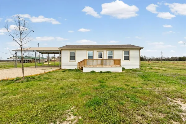 a view of a house with a backyard