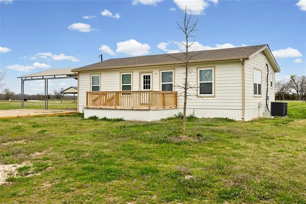 a backyard of a house with table and chairs
