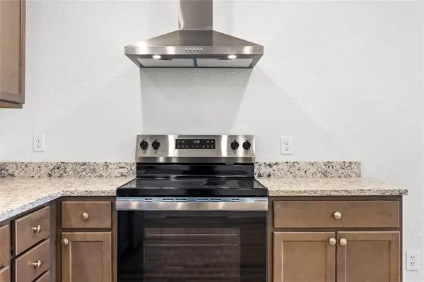 a kitchen with granite countertop a sink stainless steel appliances and cabinets