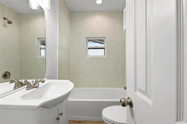 a kitchen with stainless steel appliances granite countertop a sink counter space cabinets and a large window