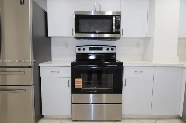 a kitchen with a stove and a microwave