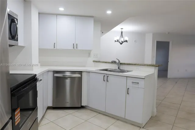 a kitchen with granite countertop a sink and a stove top oven