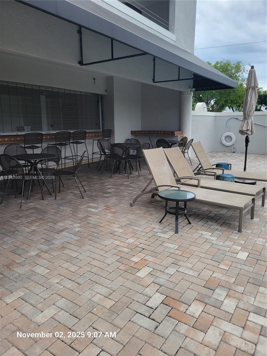 2351 Douglas Road, Unit 601 Miami, FL 33145 - Photo 19 of 36 a view of a chairs and table in a patio