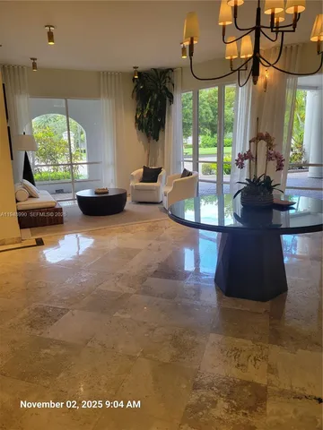 a view of a living room and a floor to ceiling window