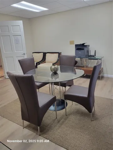 a view of a room with kitchen and dining table cabinet