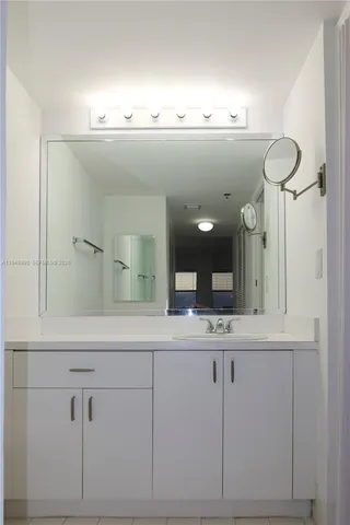 a bathroom with a sink and mirror