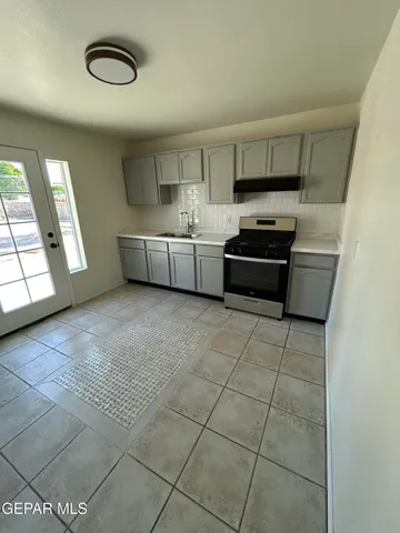 a kitchen with stainless steel appliances a cabinets and a stove top oven