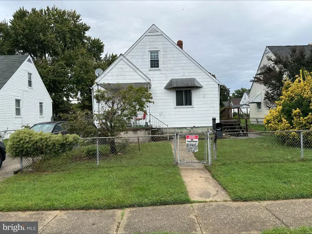 a front view of house with a garden