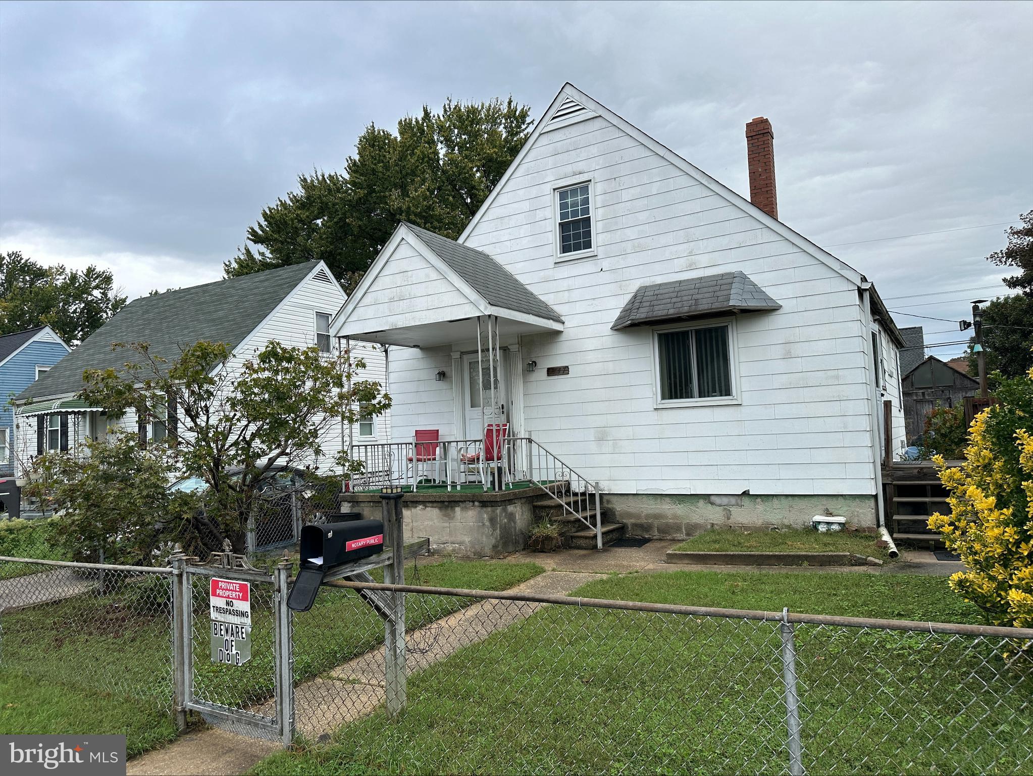 1747 Brookview Road Baltimore, MD 21222 - Photo 2 of 13 a front view of a house with a yard and potted plants
