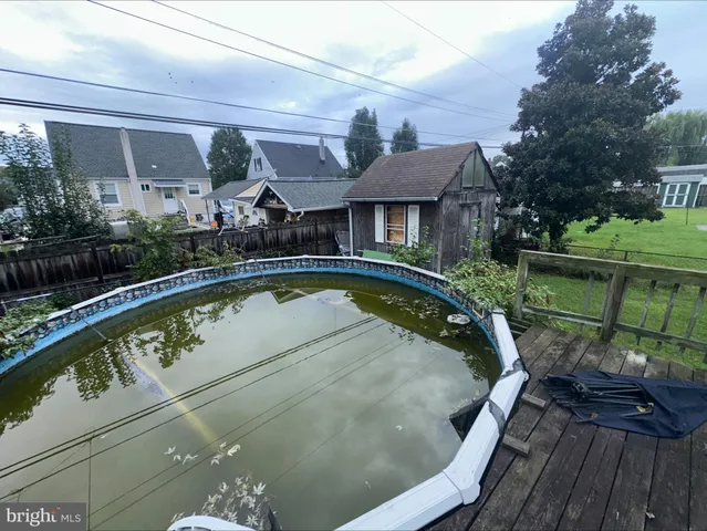 a view of a backyard with table and chairs plants and trees